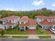 A high angle view showcases a neighborhood with manicured lawns and red tile roofs at 13007 Bromborough Dr, Orlando, FL 32832