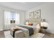 Beautifully staged bedroom features neutral tones, bright windows, and stylish decor at 13007 Bromborough Dr, Orlando, FL 32832