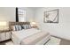 A bright bedroom features a neutral color palette, carpet, window, and a simple design at 13007 Bromborough Dr, Orlando, FL 32832