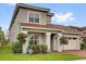 Charming home exterior featuring a well-manicured lawn and two-car garage at 13007 Bromborough Dr, Orlando, FL 32832