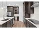 A kitchen features stainless steel appliances, dark cabinets, white countertops, and a central island with a sink at 13007 Bromborough Dr, Orlando, FL 32832