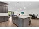 Bright kitchen boasts an oversized island, modern pendant lights, and views of the open floor plan at 13007 Bromborough Dr, Orlando, FL 32832