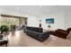 Bright living room with tile floors, large glass doors to the patio, and a comfortable seating arrangement at 13007 Bromborough Dr, Orlando, FL 32832