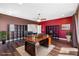 Home office with built-in shelving, a large desk, and hardwood floors at 2731 Flintlock Ave, Clermont, FL 34711