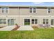 Townhome back exterior featuring green grass, patio area, and central air units at 367 Sequoia Dr, Lake Wales, FL 33859