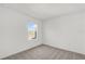This carpeted bedroom has a window view of an open field, offering a bright and simple space at 367 Sequoia Dr, Lake Wales, FL 33859