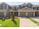 Charming townhome featuring a two-car garage, lush lawn, and a welcoming entrance at 367 Sequoia Dr, Lake Wales, FL 33859