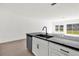 Open-concept kitchen with sleek black countertops and stainless steel appliances at 367 Sequoia Dr, Lake Wales, FL 33859