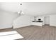 Spacious living room featuring staircase, light hardwood floors, and modern chandelier at 367 Sequoia Dr, Lake Wales, FL 33859