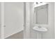 Clean, modern bathroom with pedestal sink and tile flooring at 375 Sequoia Dr, Lake Wales, FL 33859