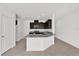 Modern kitchen featuring granite countertops, dark cabinetry and stainless steel appliances at 375 Sequoia Dr, Lake Wales, FL 33859