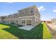 Backyard view of the new home, showcasing a patio and grassy area at 410 Sequoia Dr, Lake Wales, FL 33859