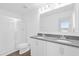 Bright primary bathroom featuring a double sink vanity, quartz countertops, and a glass enclosed shower at 410 Sequoia Dr, Lake Wales, FL 33859