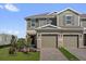 Charming two-story townhome with a well-maintained lawn and brick driveway at 410 Sequoia Dr, Lake Wales, FL 33859