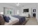 A well-lit bedroom with a walk-in closet, and a view of a glass door leading to a screened patio at 4112 Aberdeen Ln, Lake Wales, FL 33859