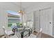 Dining room with glass table, white chairs, and natural light at 4112 Aberdeen Ln, Lake Wales, FL 33859
