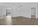 Bright dining area with a decorative chandelier, light wood flooring, and views into adjoining rooms at 4112 Aberdeen Ln, Lake Wales, FL 33859