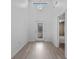 Bright foyer with light wood floors, a decorative chandelier, and a glass-paneled front door at 4112 Aberdeen Ln, Lake Wales, FL 33859