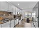 Bright kitchen featuring white cabinets, stainless steel appliances, and an adjacent dining area at 4112 Aberdeen Ln, Lake Wales, FL 33859