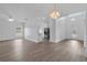 Open-concept living room with wood floors, pendant lighting, and natural light at 4112 Aberdeen Ln, Lake Wales, FL 33859