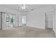 Bright main bedroom with carpet, ceiling fan, closet, and sliding glass doors to a sunroom at 4112 Aberdeen Ln, Lake Wales, FL 33859