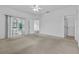 Bright main bedroom with carpet, ceiling fan, closet, and sliding glass doors to a sunroom at 4112 Aberdeen Ln, Lake Wales, FL 33859