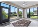Light-filled sunroom featuring tiled floors, views of the backyard, and a ceiling fan at 4112 Aberdeen Ln, Lake Wales, FL 33859