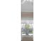 An interior shot of a window with views of a palm tree and neighborhood at 4112 Aberdeen Ln, Lake Wales, FL 33859