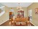 Formal dining room with hardwood floors, chandelier lighting, and adjacent living areas at 497 Lakepark Trl, Oviedo, FL 32765