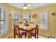 Cozy breakfast nook with a tiled table and window seating at 5025 St Andrews Arc, Leesburg, FL 34748