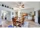 Open dining area with hardwood floors and views of kitchen at 5025 St Andrews Arc, Leesburg, FL 34748