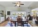 Light-filled dining area with a wooden table and chairs, open to the living room at 5025 St Andrews Arc, Leesburg, FL 34748