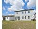 View of the backyard with a lawn and the rear of the house at 5714 Cattle Ranch Dr, St Cloud, FL 34771