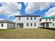 View of the backyard with a lawn and the rear of the house at 5714 Cattle Ranch Dr, St Cloud, FL 34771