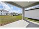 View of the backyard from the covered porch, showcasing the lawn at 5714 Cattle Ranch Dr, St Cloud, FL 34771