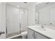 Modern bathroom featuring a glass shower, white tile, and a vanity with quartz countertop at 5714 Cattle Ranch Dr, St Cloud, FL 34771