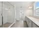 Spacious bathroom with a large glass shower, double vanity, and neutral-toned tile flooring at 5714 Cattle Ranch Dr, St Cloud, FL 34771