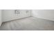 Bright bedroom featuring plush carpeting, and natural light from two windows overlooking the neighborhood at 5714 Cattle Ranch Dr, St Cloud, FL 34771