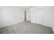 Spacious bedroom features neutral carpeting and a closet at 5714 Cattle Ranch Dr, St Cloud, FL 34771