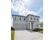 Charming two-story home featuring a two-car garage and manicured front lawn at 5714 Cattle Ranch Dr, St Cloud, FL 34771