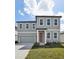 Charming two-story home with a garage, and landscaped front yard at 5714 Cattle Ranch Dr, St Cloud, FL 34771