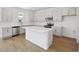 Modern kitchen with stainless steel appliances, gray cabinets, and a center island with white countertop at 5714 Cattle Ranch Dr, St Cloud, FL 34771