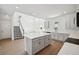 Modern kitchen and staircase featuring stainless steel appliances, gray cabinetry, and a large center island at 5714 Cattle Ranch Dr, St Cloud, FL 34771