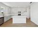 Bright kitchen featuring stainless steel appliances, white cabinets, and a center island with a countertop at 5714 Cattle Ranch Dr, St Cloud, FL 34771