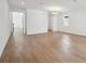Bright, open living room with wood-style tile floors and modern lighting at 5714 Cattle Ranch Dr, St Cloud, FL 34771