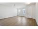 Bright, open living room with wood-style tile floors and modern lighting at 5714 Cattle Ranch Dr, St Cloud, FL 34771
