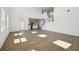 Bright, open living room featuring soaring ceilings, wood-look tile floors, and an adjacent kitchen area at 5714 Cattle Ranch Dr, St Cloud, FL 34771