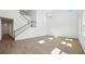 Open living room showcasing the staircase and tile flooring at 5714 Cattle Ranch Dr, St Cloud, FL 34771