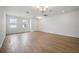 Bright, open living room with wood-style tile floors and modern lighting at 5714 Cattle Ranch Dr, St Cloud, FL 34771