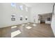 Bright open living room with natural light and tile flooring leads to the kitchen at 5714 Cattle Ranch Dr, St Cloud, FL 34771